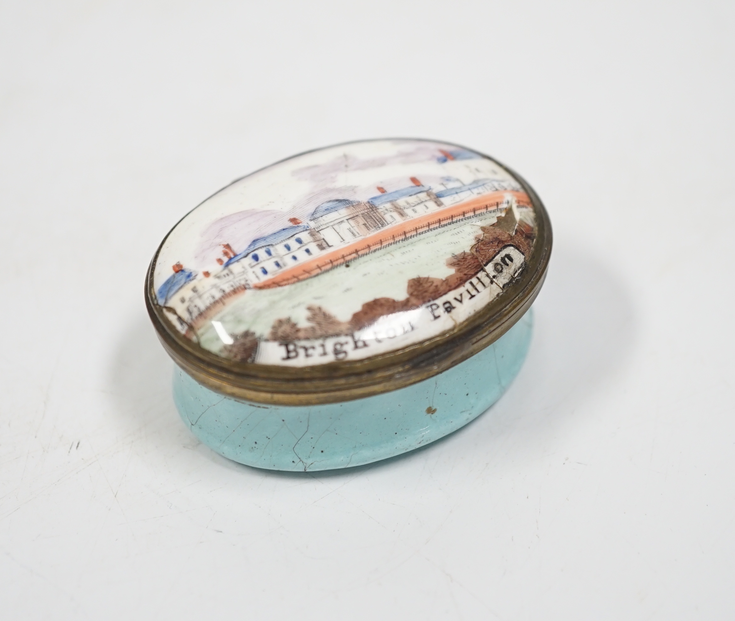 A rare South Staffordshire enamel patch box with an early view of Henry Holland’s Brighton pavilion, c.1800, 5 cm across, a/f